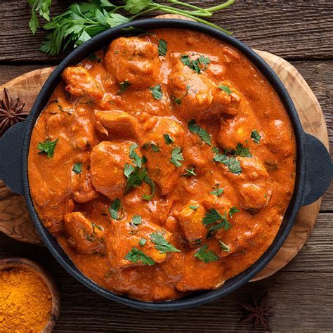 A bowl of rich curry garnished with herbs, representing a blog about a wide range of halal food options from curries to fusion dishes.