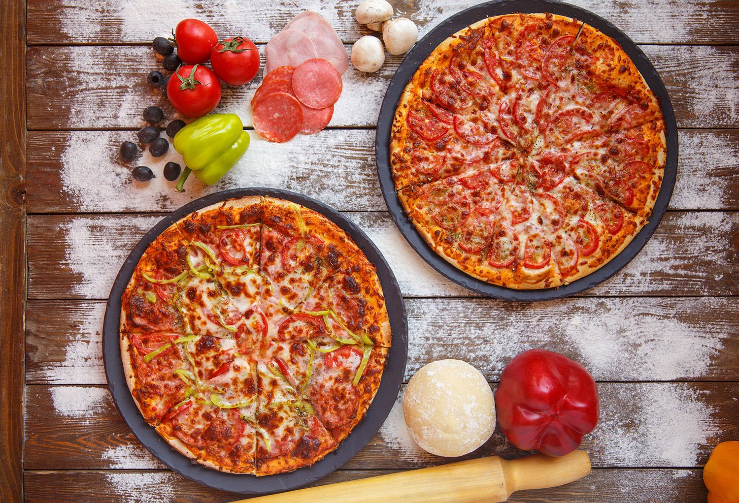 Two pizzas topped with vibrant ingredients and spices, representing a blog about specialty fusion pizzas combining curry flavors and classic pizza styles.