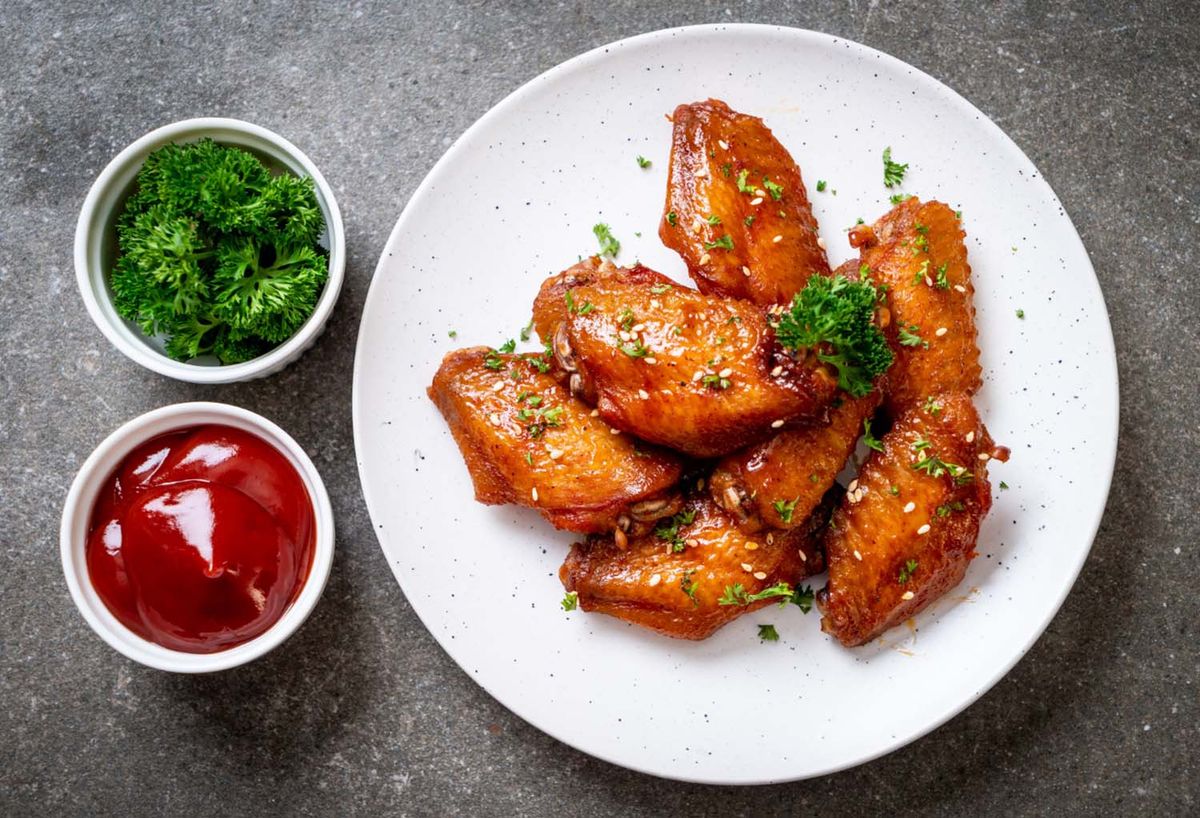 A plate of crispy halal chicken wings served with dipping sauces, representing a blog about flavorful chicken wing combos available in California.